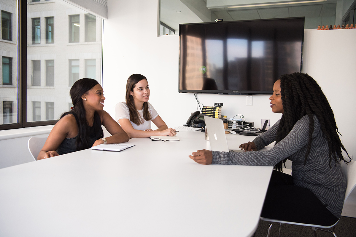 Three females sitting in an advising setting